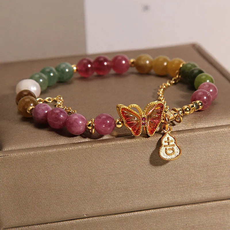 Women's tourmaline butterfly gourd bracelet with agate, showing jade coloured carved centrepiece.
