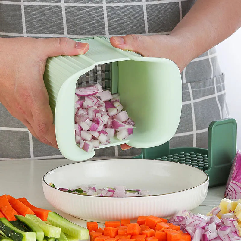 Green manual vegetable chopper with stainless steel blades for slicing potatoes and dicing onions.