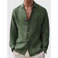 Man wearing a loose-fit striped long sleeve cardigan-style shirt in a casual setting.