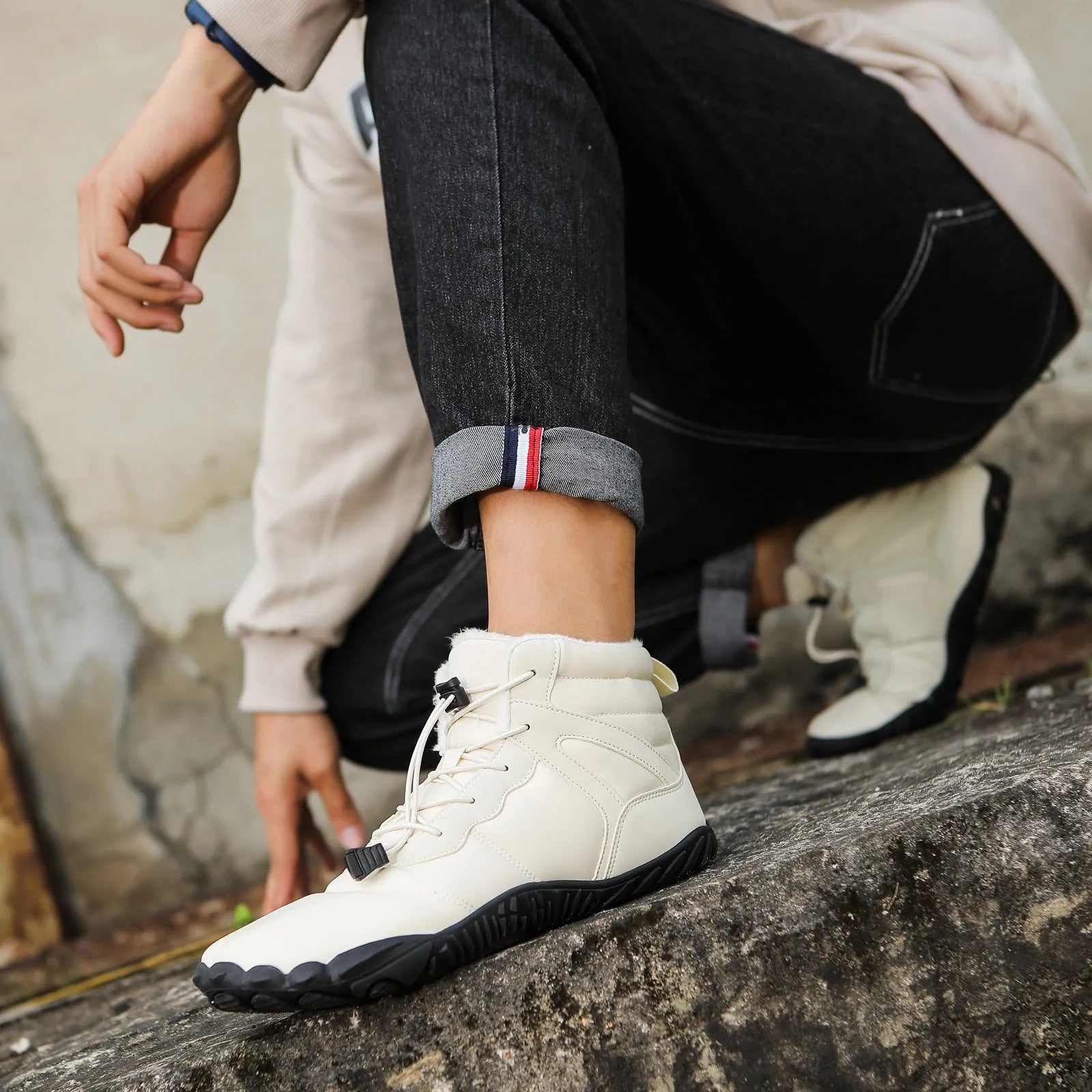 Beige five-finger waterproof snow boots with rubber sole and fleece lining on outdoor ground.