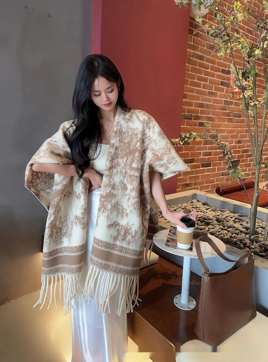 Women's casual scarf cape with tassel trim, shown in a selection of colours.