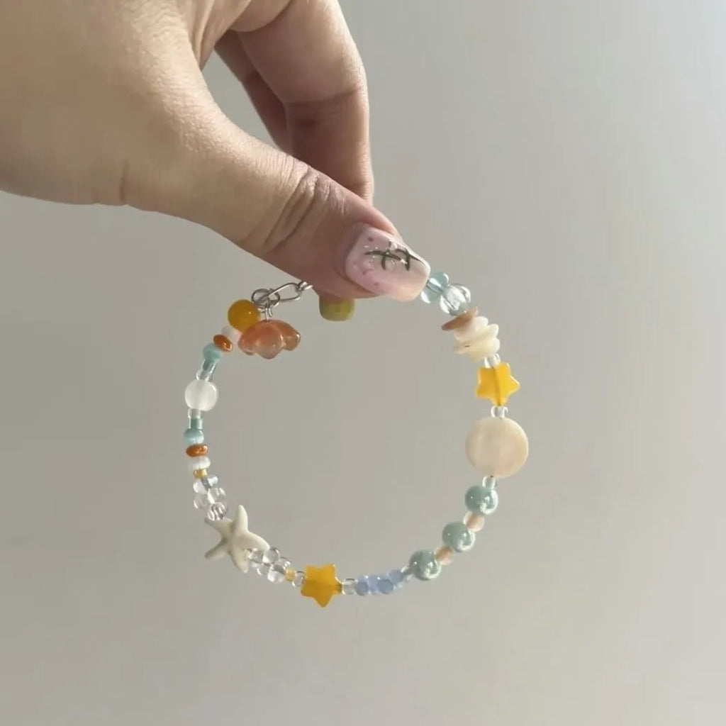 Orange gold-tone bracelet with water-soaked texture, diamond shape and round decorative elements