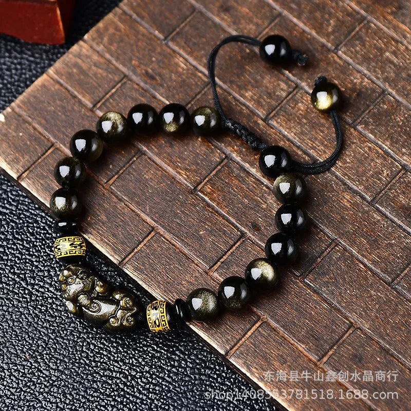 Original hand-woven golden obsidian Pi Xiu bracelet showing bead detail and Chinese style design