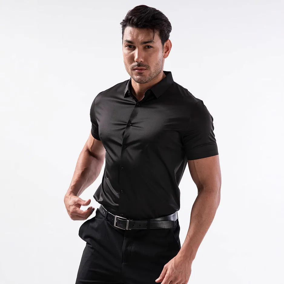 Man wearing a grey short sleeve cardigan-style shirt made from elastic non-iron fabric.