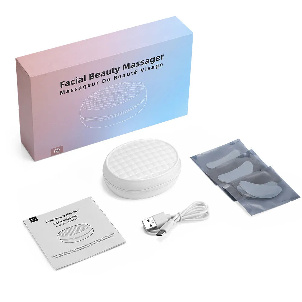White wireless red light and EMS eye and facial massager beauty device on a plain background.
