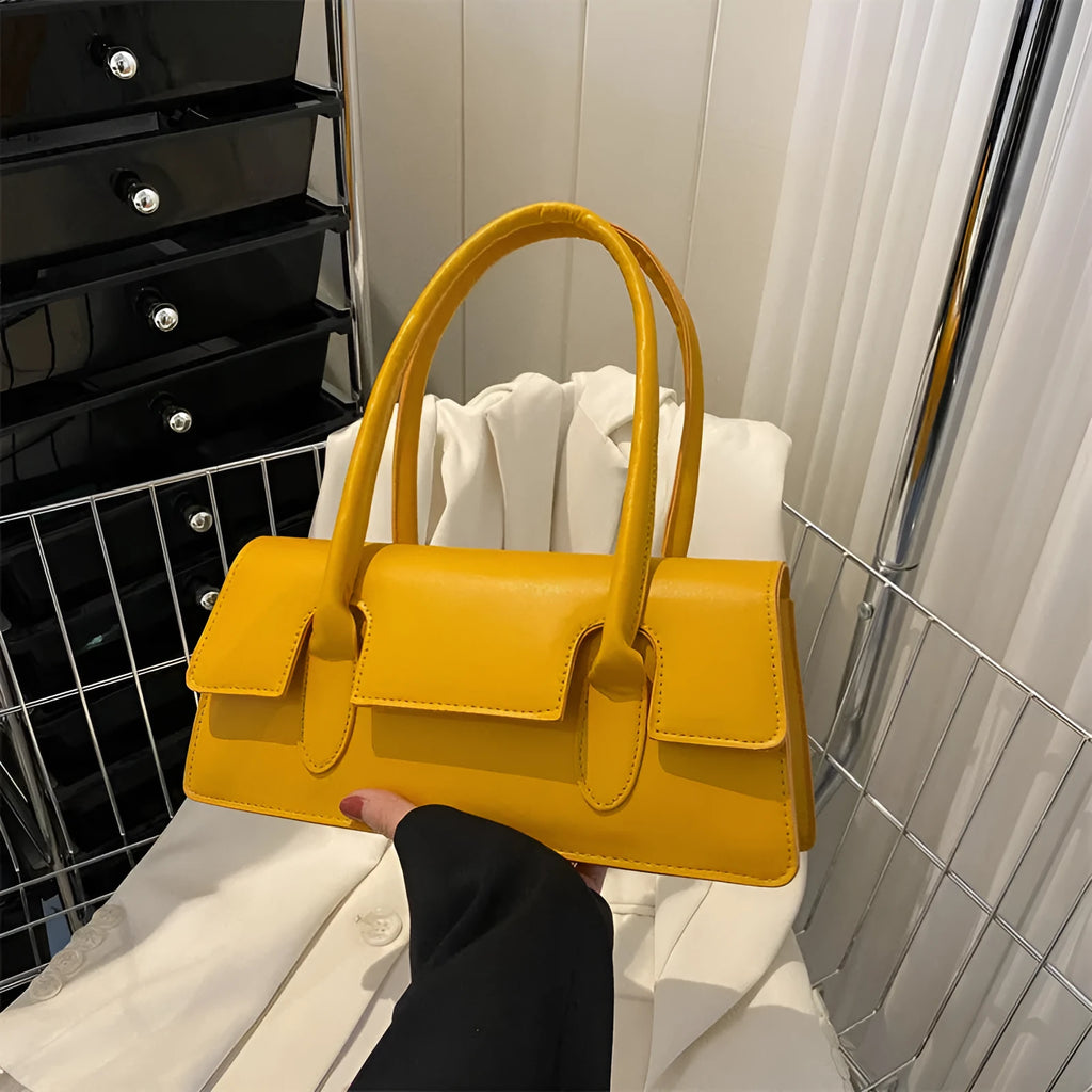 Women's small horizontal square shoulder bag in PU leather with single strap and stitching detail.