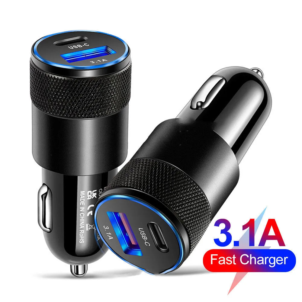 Aluminium alloy twin USB car charger shown in black, plugged into a car dashboard 12V socket.