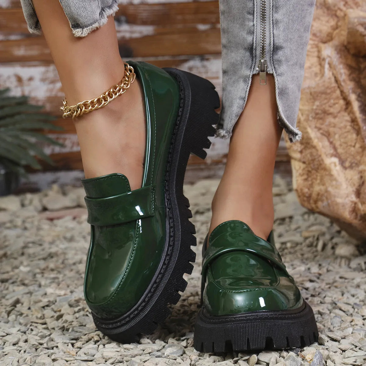 Women's plus size black slip-on loafers with a chunky platform heel and mid-top design.