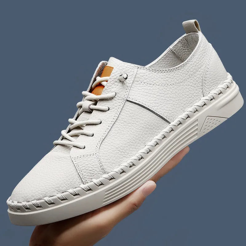 Men's beige cowhide leather casual sneakers with round toe and visible stitching.