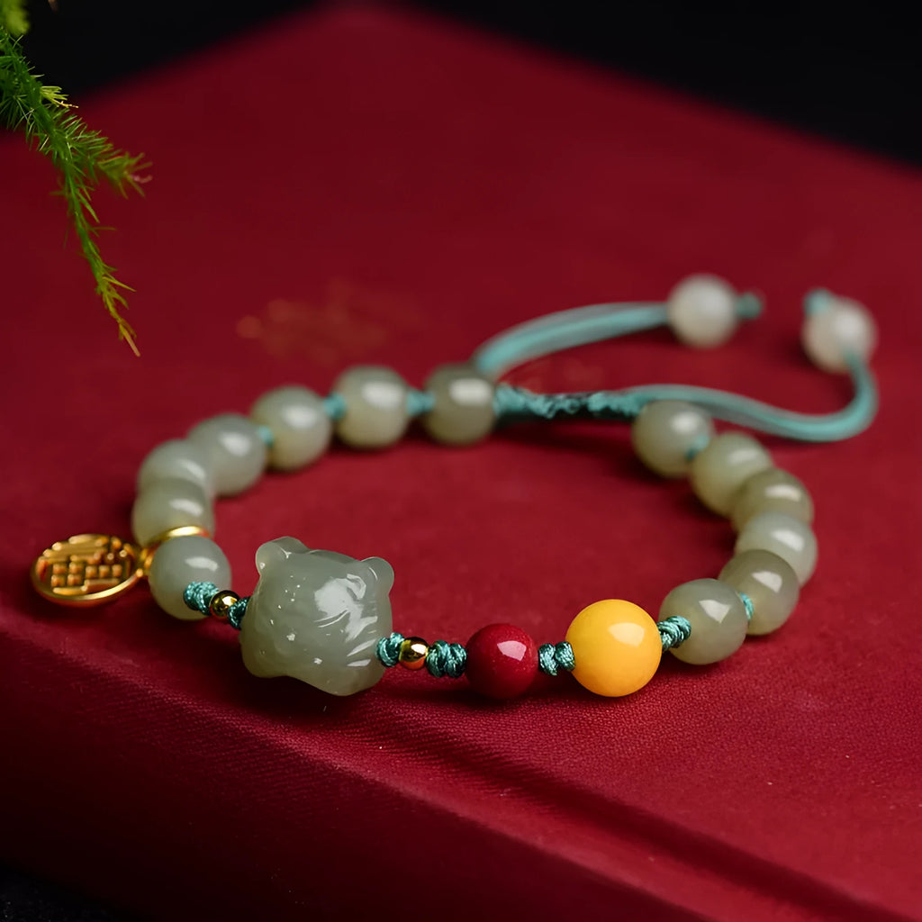 Natural Hetian Jade bracelet with cinnabar and beeswax beads in animal zodiac design.