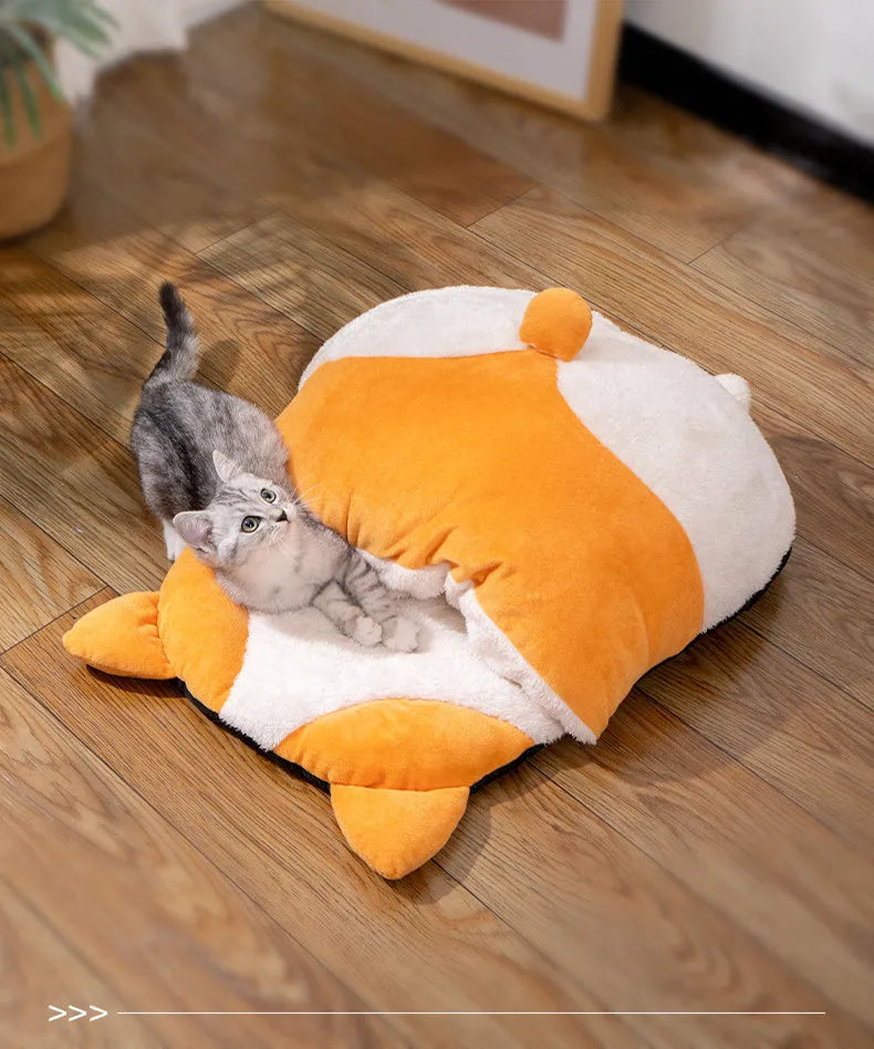 Orange semi-enclosed cat sleeping bag bed on a floor, showing its nest shape and dimensions.