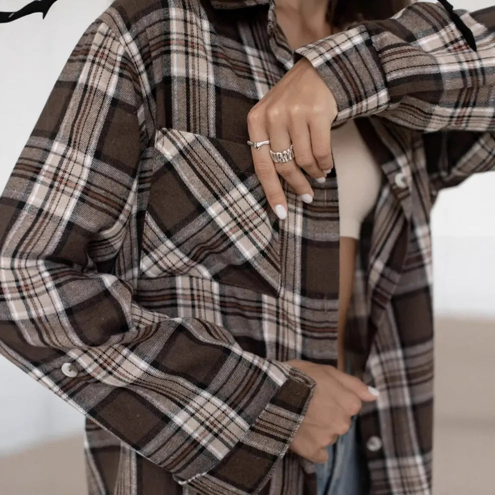 Dark brown striped women's long sleeve retro shirt on a hanger, showing collar and sleeve detail.