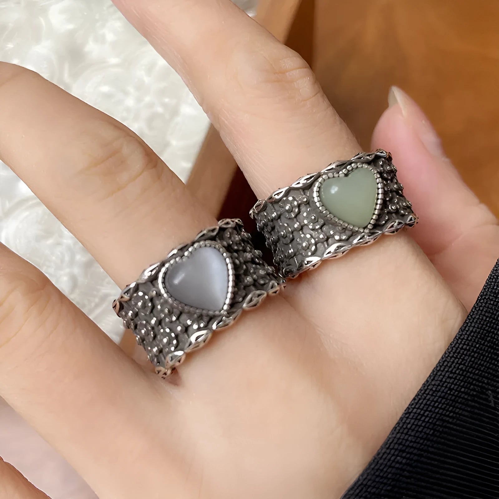 Retro wide-faced silver heart ring with adjustable opening on a white background.