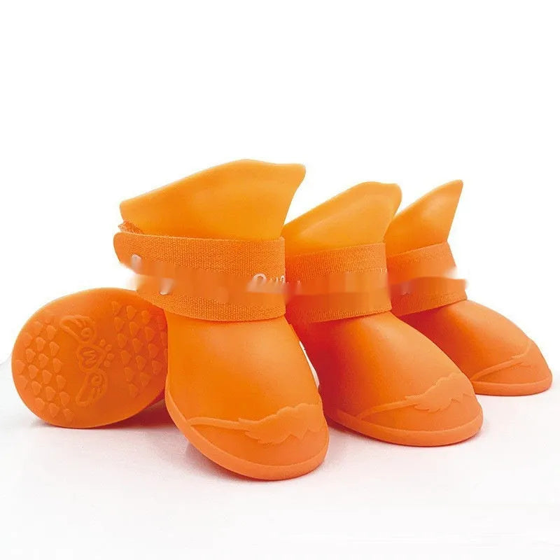 Set of four colourful rubber pet rain shoes with soft soles for dogs or cats.