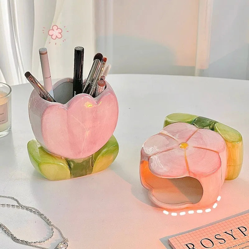Ceramic flower pen holder in a floral pattern, showing its size next to pens for scale.