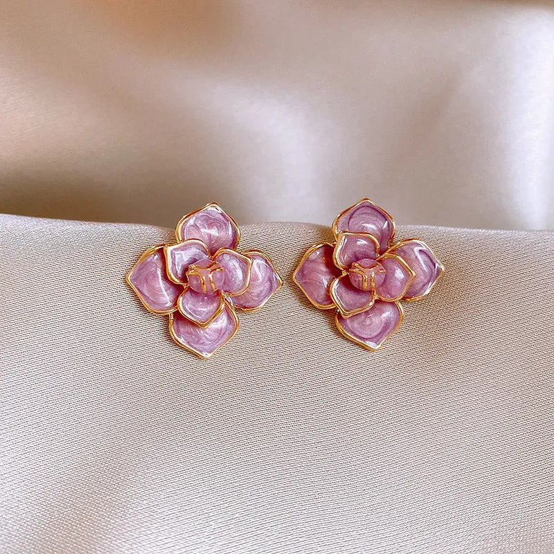 Gold plated purple flower stud earrings with copper base and fresh floral style on silver needle