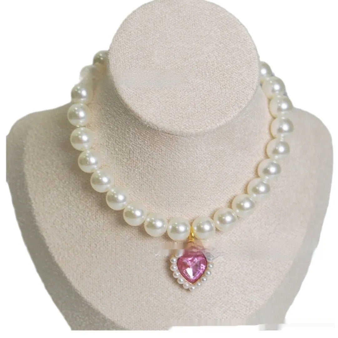 Cat collar with plastic heart charm in blue, shown alongside pink, green, purple, transparent and sapphire blue colour options