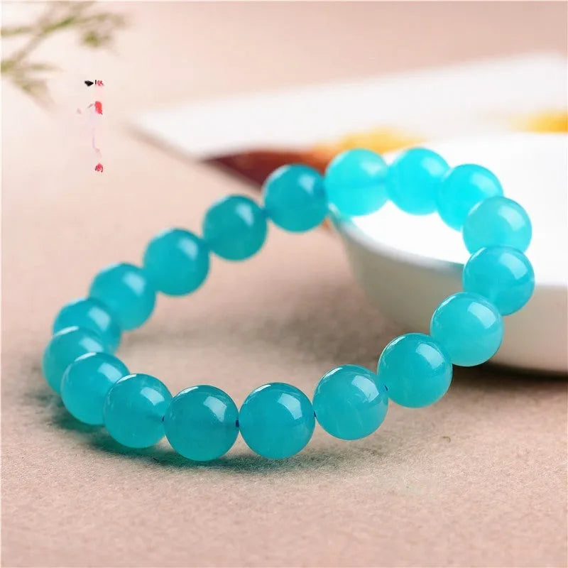 Natural blue-green Amazonite scattered bead bracelet on a wrist, showing polished stone beads in an original design.