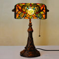 10-inch Tiffany style desk lamp with coloured stained glass shade and matching resin base on a wooden table.