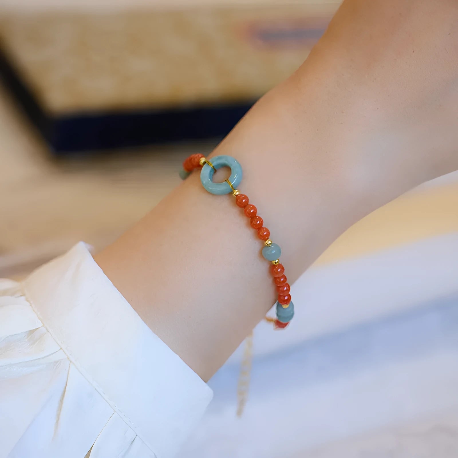 Women's South Red Agate bracelet with geometric patterns and an adjustable safety buckle.