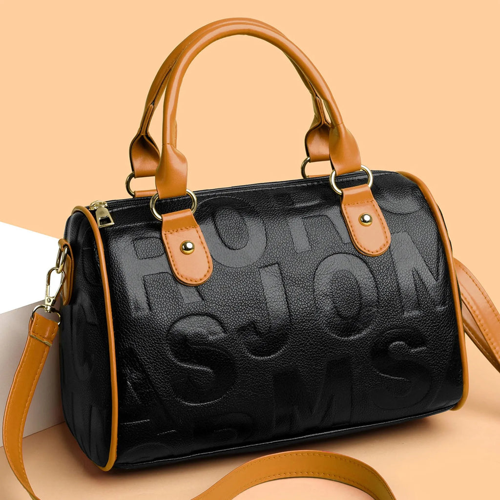 Brown cylindrical PU leather crossbody bag with three shoulder straps showing interior polyester lining