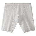 Men's white lace boxer shorts showing lengthened cut and mid-waist design on a neutral background.