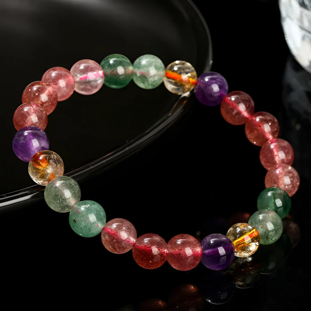 Women's strawberry quartz gemstone bracelet with round beads in a geometric pattern.