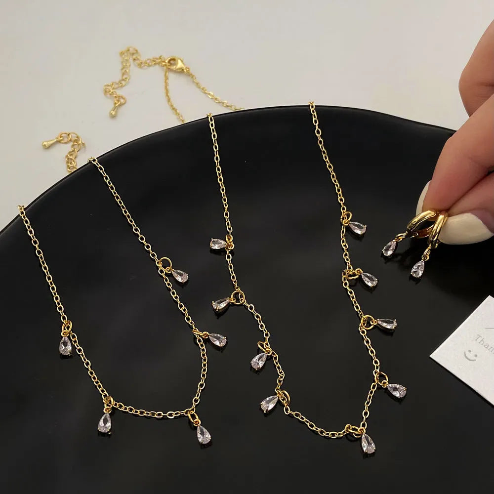Women's zircon jewellery set with geometric pendant necklace, matching earrings and anklet in meteor shower design