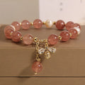 Women's bracelet with strawberry quartz beads, freshwater pearls, and metallic charms in Japanese Korean jewellery style