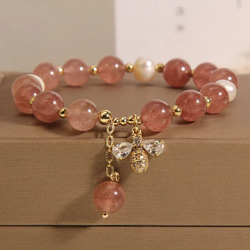 Women's bracelet with strawberry quartz beads, freshwater pearls, and metallic charms in Japanese Korean jewellery style