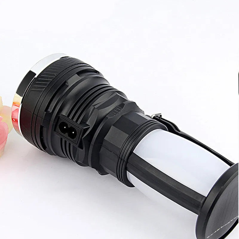 Black solar-powered LED emergency flashlight with USB charging port.