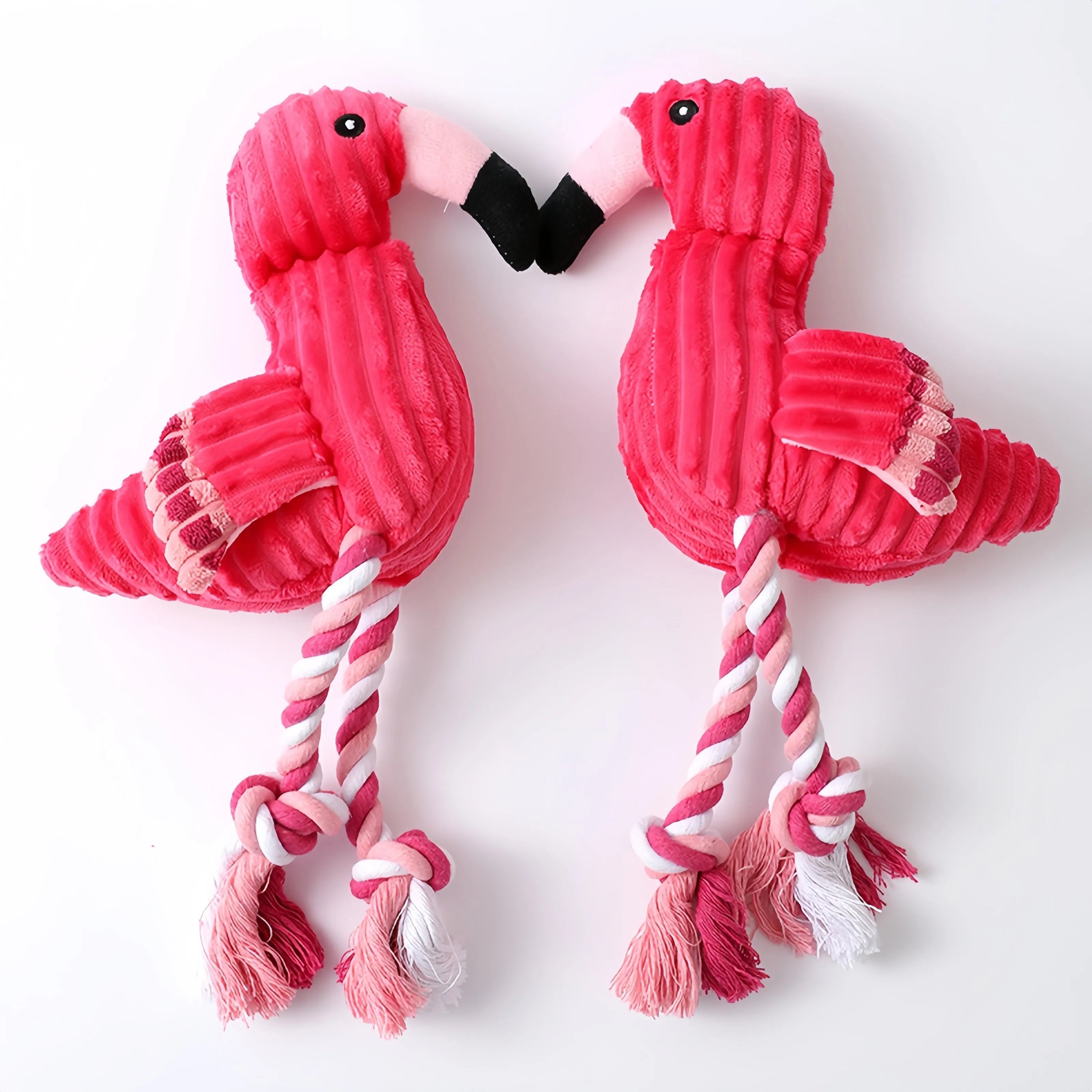Pink corduroy animal-shaped dog toy with internal squeaker for bite-resistant play.