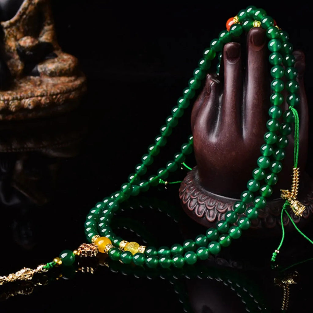 Close-up of a multi-circle green agate bracelet with natural stone beads on a wrist.
