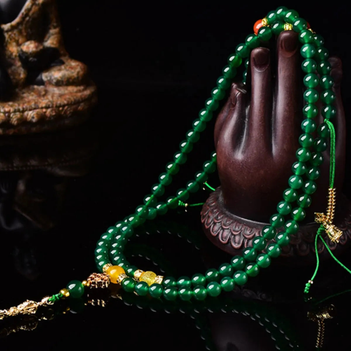 Close-up of a multi-circle green agate bracelet with natural stone beads on a wrist.