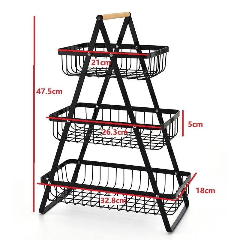 Black detachable iron double-layer fruit basket with a wooden handle on a kitchen counter.