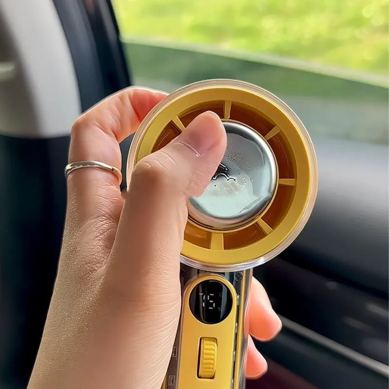 Small yellow handheld portable fan with refrigeration ice compress function showing compact design