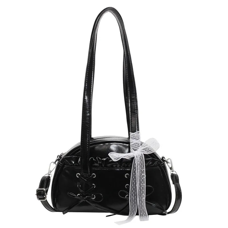 Women's PU leather handbag with bandage bow detail showing internal mobile phone pocket