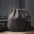 Vintage cowhide drawstring bundle wallet in genuine leather showing drawstring closure and sewing thread details