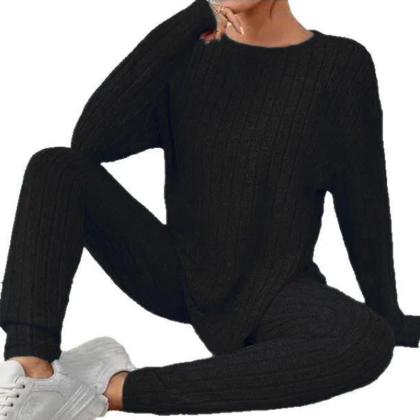 Sunken stripe black polyester two-piece homewear set showing trousers and top on Asian size mannequin