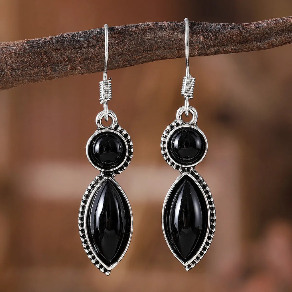 A pair of vintage-style geometric earrings with a black and purple electroplated finish on a zinc alloy base.