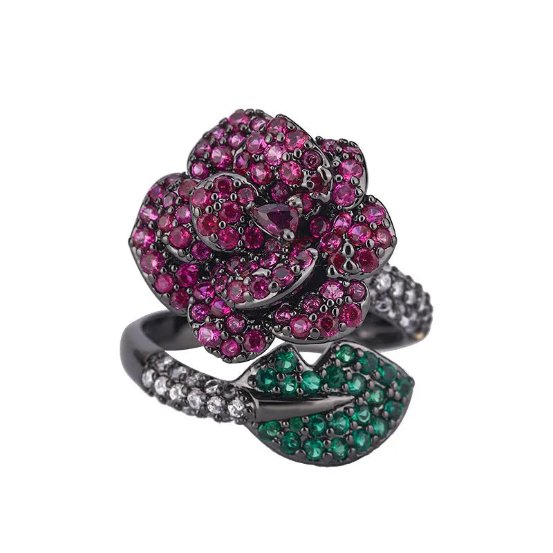 Geometric black gold ring with red simulated corundum centrepiece in flower design