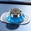 Magnetic car air freshener unit in Gentleman's Black or Qian Shan Cui colour, shown with fragrance fluid.