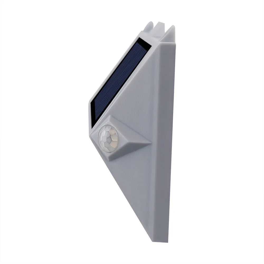 Solar-powered outdoor step light with motion sensor in abstract design for mounting on walls or steps.