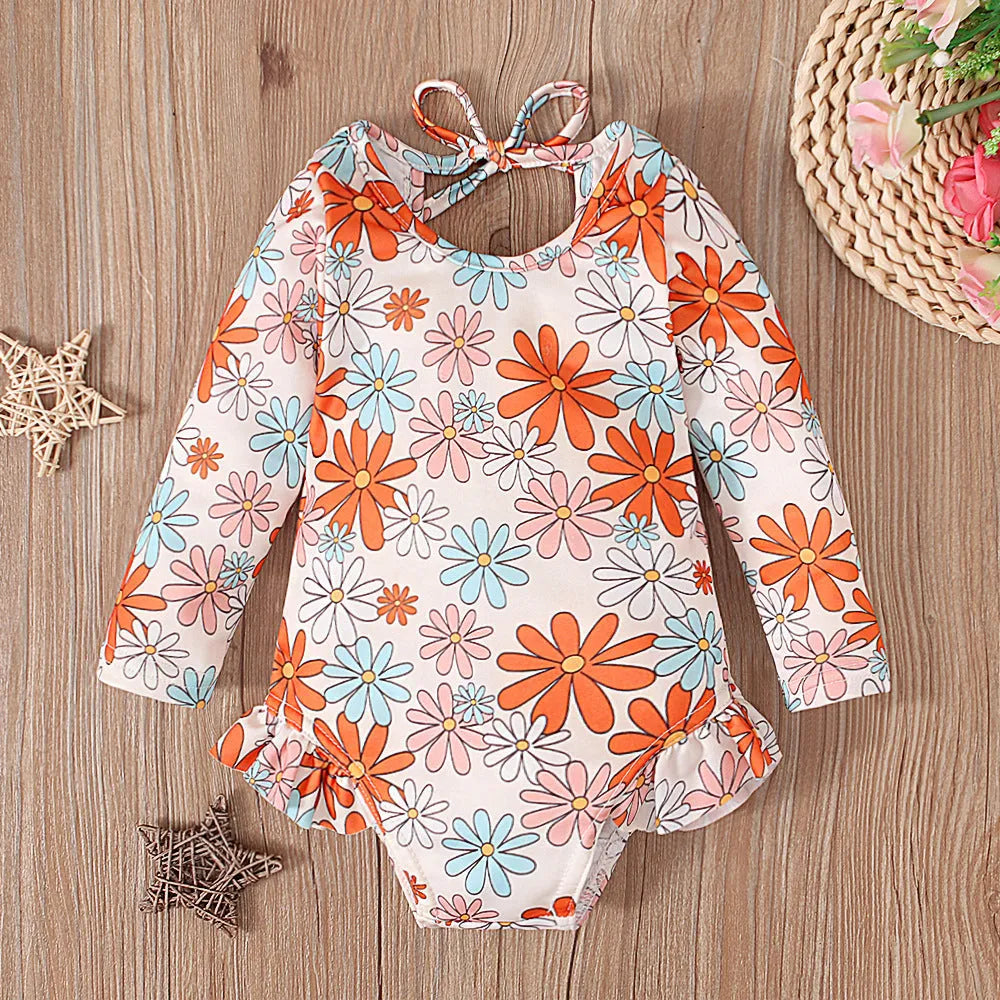 Girl's floral print open back swimsuit in orange red, shown from front and back.