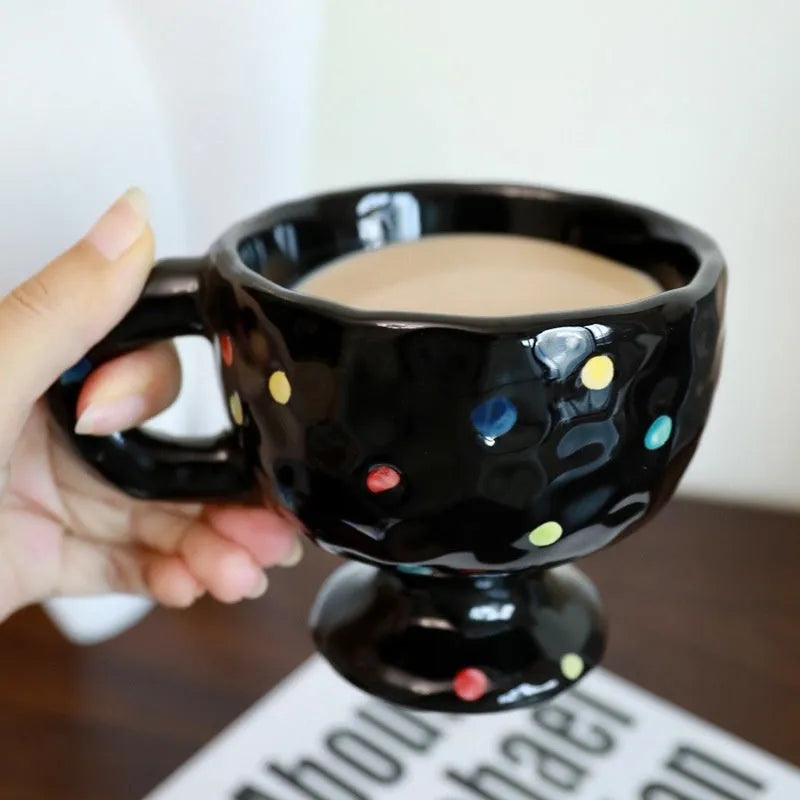 Hand-pinched irregular shaped ceramic mug in a solid colour, showing its unique handmade form.