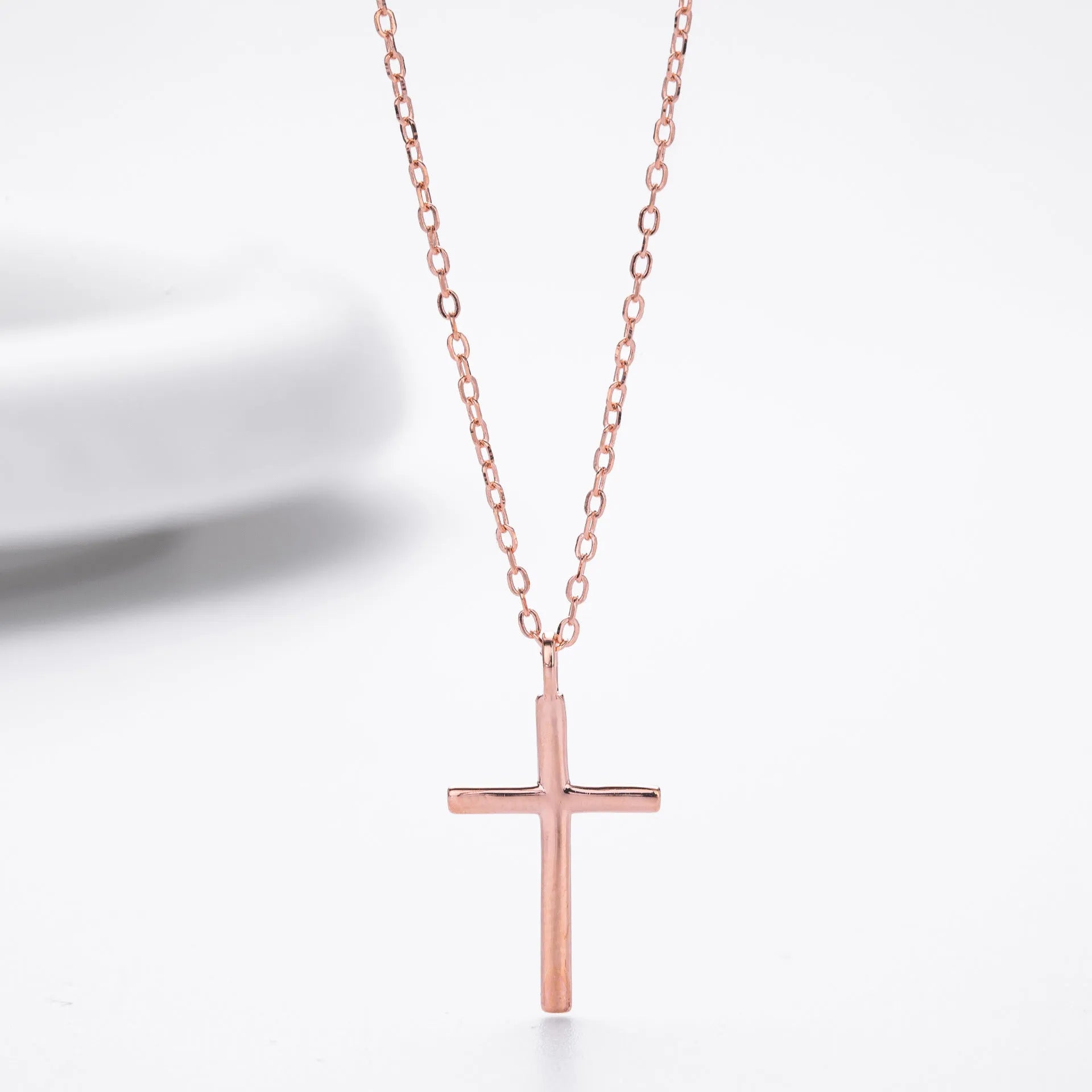 Sterling silver necklace with cross pendant on O-shaped chain showing gold electroplated finish