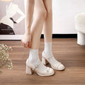 Apricot patent leather women's shoes with chunky heel, round toe, and buckle fastening.