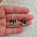 Pair of alloy vintage sewing machine earrings with oil drip finish in black colour