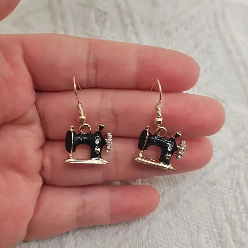 Pair of alloy vintage sewing machine earrings with oil drip finish in black colour