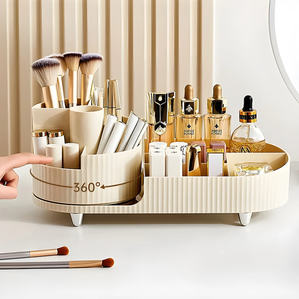 Rotating cream and black cosmetics organiser box holding makeup brushes and lipsticks on a table.